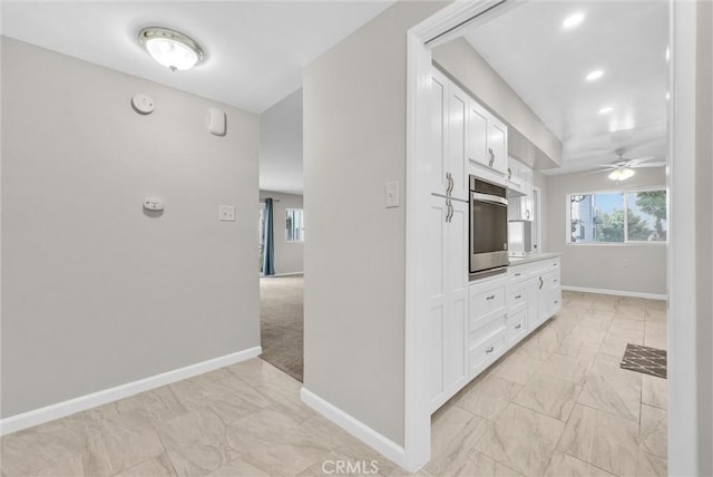 kitchen with light countertops, white cabinetry, and baseboards