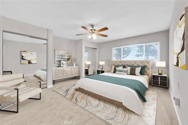 bedroom with ceiling fan, carpet flooring, and baseboards