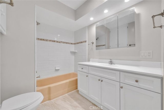 bathroom featuring  shower combination, recessed lighting, toilet, and vanity