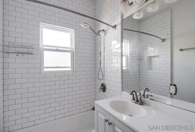 bathroom featuring vanity and tiled shower / bath combo