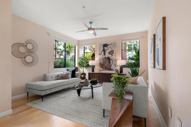 living room featuring light hardwood / wood-style floors and ceiling fan