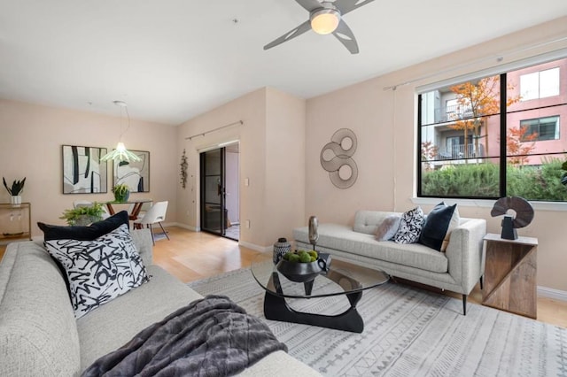 living room featuring ceiling fan and light wood-type flooring