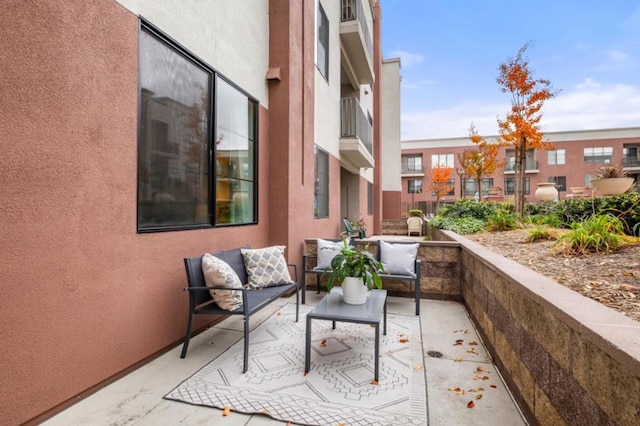 balcony with an outdoor living space and a patio