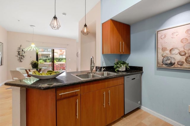 kitchen featuring dishwasher, sink, kitchen peninsula, and decorative light fixtures