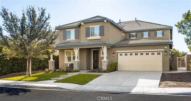 view of front of house featuring a garage and a front lawn