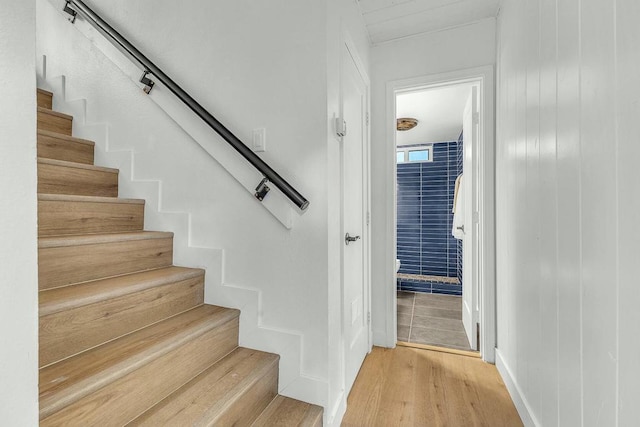 staircase with hardwood / wood-style flooring