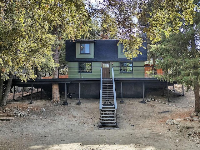 rear view of house featuring a wooden deck