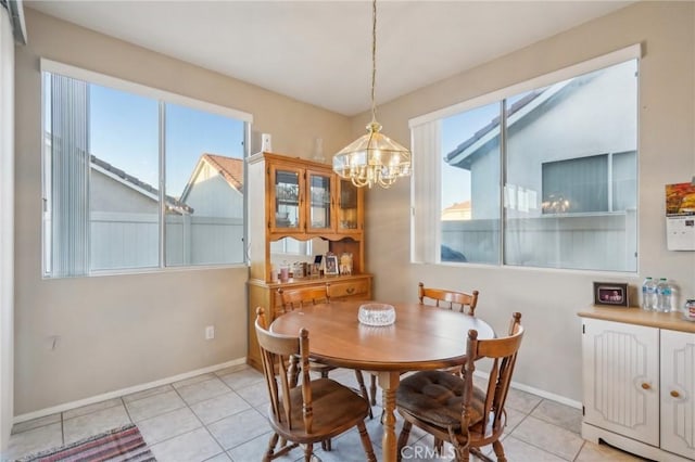 dining room featuring light tile patterned floors, an inviting chandelier, and a wealth of natural light