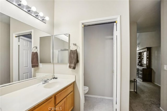 bathroom with tile patterned floors, vanity, and toilet