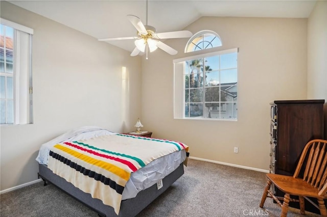 bedroom featuring dark carpet, vaulted ceiling, and ceiling fan