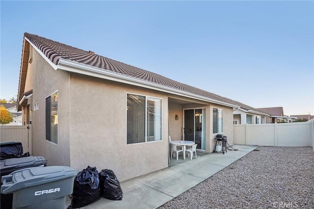 back of house with a patio