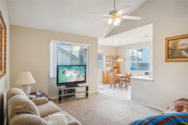 living room with light carpet, vaulted ceiling, and ceiling fan