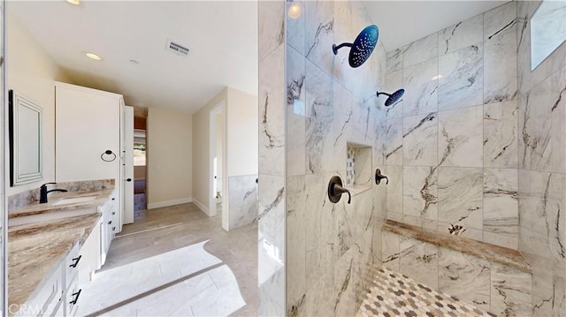 bathroom featuring vanity and tiled shower