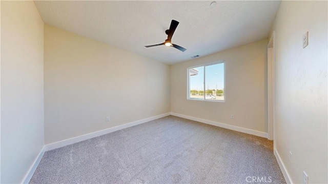 spare room with light colored carpet and ceiling fan