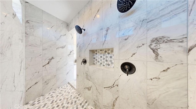 bathroom with a tile shower