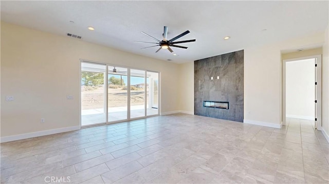 unfurnished living room with a tile fireplace and ceiling fan