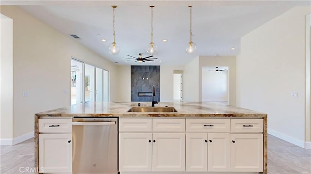 kitchen featuring light stone countertops, sink, stainless steel dishwasher, a kitchen island with sink, and white cabinets