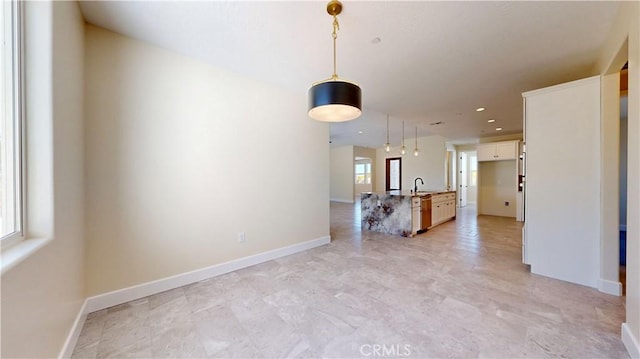 unfurnished living room featuring sink