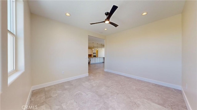 unfurnished room with ceiling fan