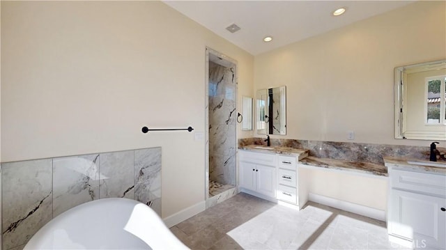 bathroom with vanity and tiled shower