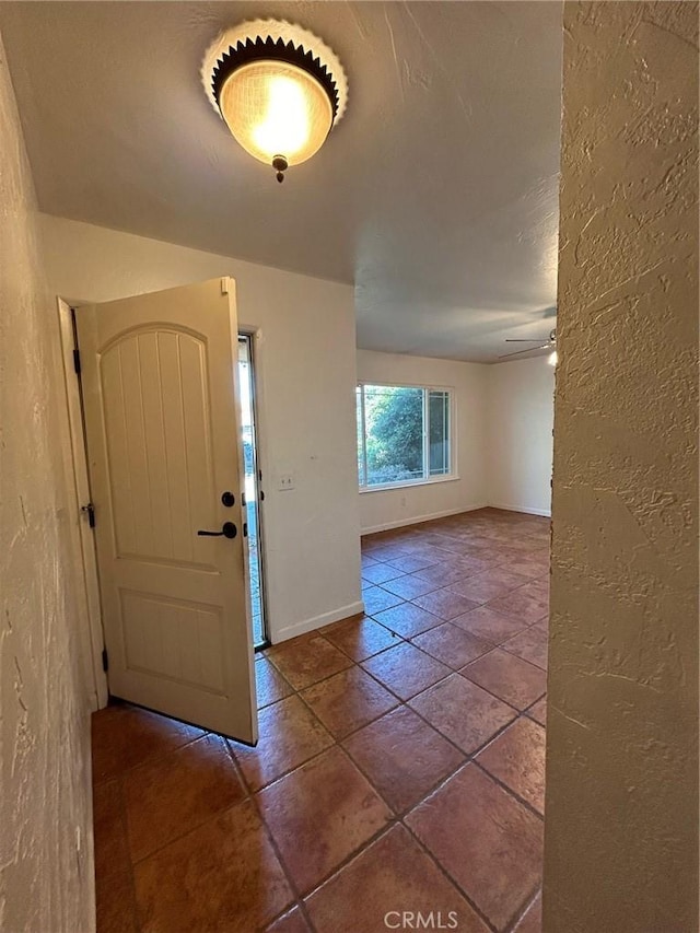 entryway with ceiling fan and tile patterned flooring