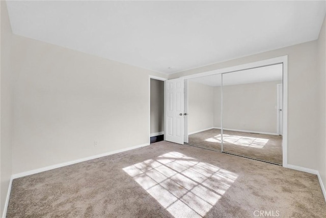 unfurnished bedroom with carpet flooring and a closet