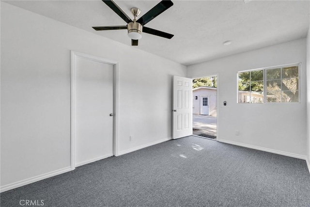 carpeted empty room featuring ceiling fan