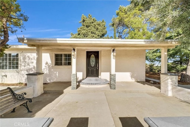 doorway to property with a porch