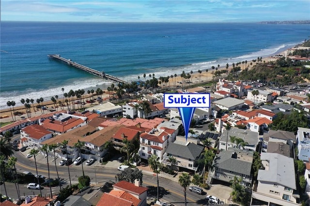 birds eye view of property with a water view and a view of the beach