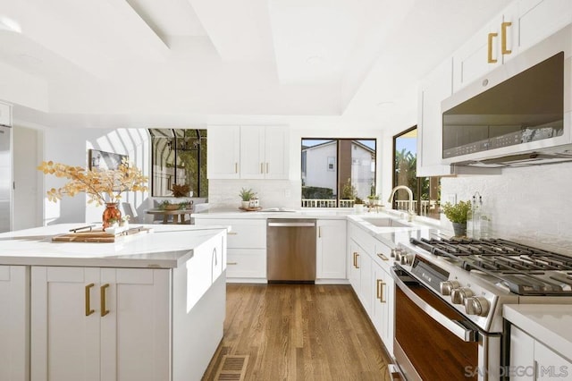 kitchen with white cabinets, sink, and appliances with stainless steel finishes