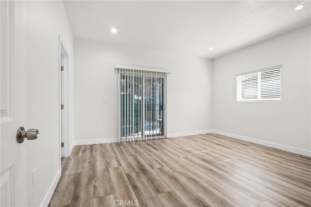 spare room featuring light hardwood / wood-style flooring