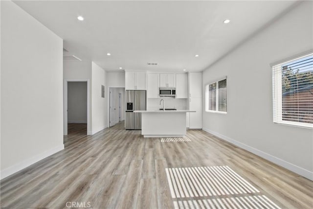 unfurnished living room with light hardwood / wood-style floors