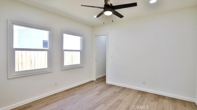 spare room with ceiling fan and light hardwood / wood-style flooring