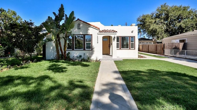 mediterranean / spanish home with a front yard