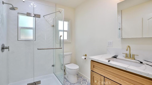 bathroom featuring vanity, toilet, and an enclosed shower