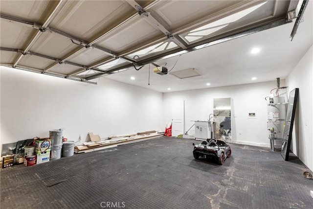 garage featuring strapped water heater and a garage door opener