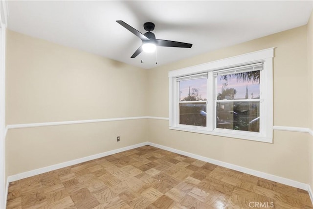 unfurnished room featuring ceiling fan and light parquet flooring