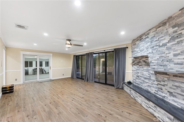 unfurnished living room featuring light wood-type flooring, ceiling fan, and crown molding