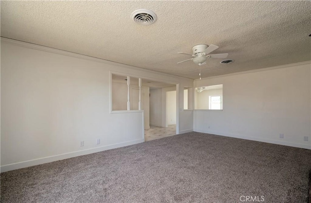 empty room featuring ceiling fan, light colored carpet, and a textured ceiling