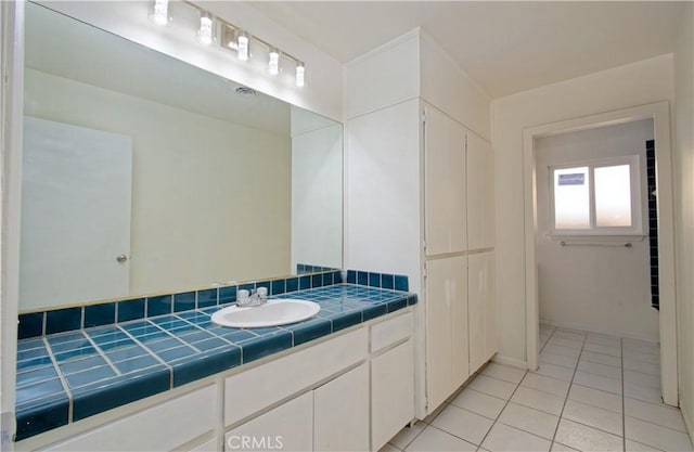 bathroom with tile patterned floors and vanity