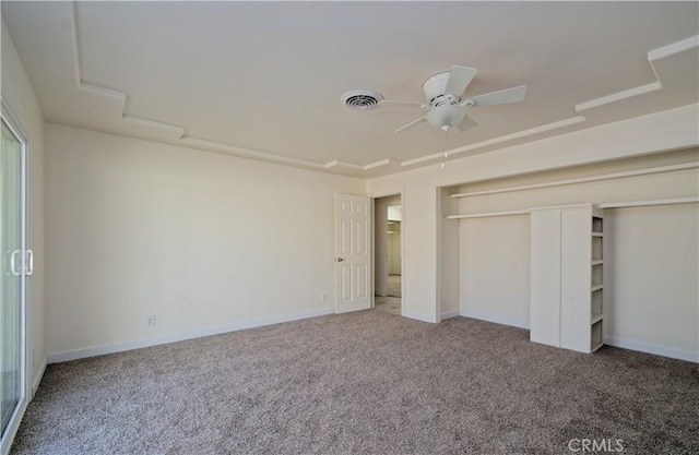 unfurnished bedroom with carpet, a closet, and ceiling fan