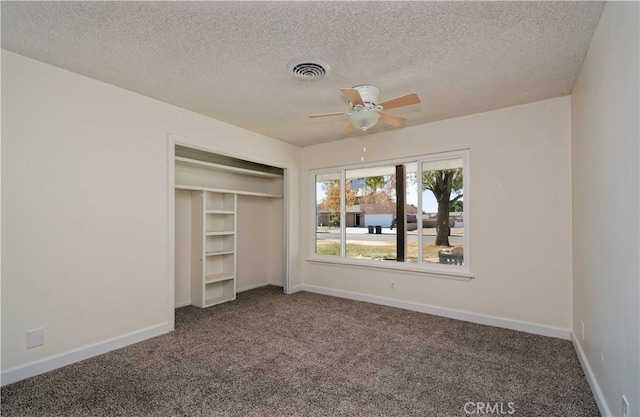 unfurnished bedroom with ceiling fan, a closet, and carpet floors