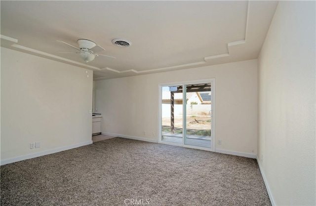 carpeted spare room with ceiling fan