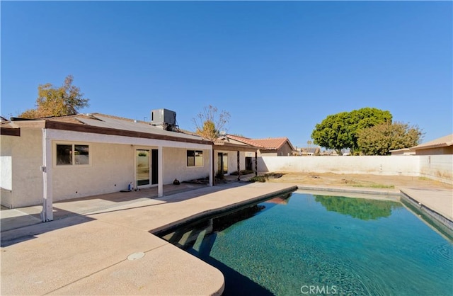 view of pool featuring cooling unit and a patio area