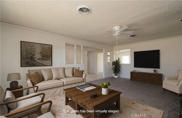 living room featuring light carpet, a textured ceiling, and ceiling fan