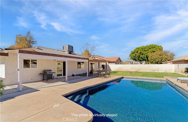 view of pool with area for grilling, a patio area, and central air condition unit