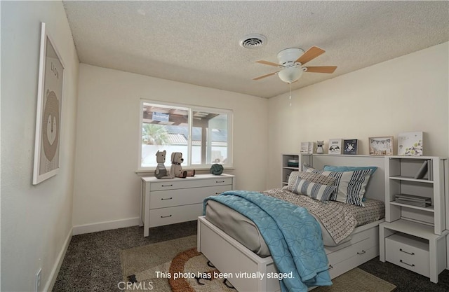 carpeted bedroom featuring a textured ceiling and ceiling fan