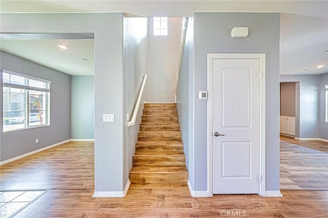 staircase with hardwood / wood-style flooring