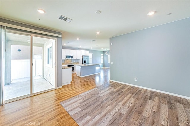 unfurnished living room with light hardwood / wood-style floors