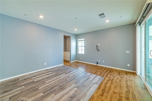 unfurnished room with light hardwood / wood-style floors